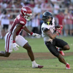 
              Cincinnati receiver Tre Tucker, right, tries to get past Arkansas defensive back Jayden Johnson, left, during the second half of an NCAA college football game Saturday, Sept. 3, 2022, in Fayetteville, Ark. (AP Photo/Michael Woods)
            