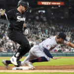 
              Chicago White Sox's AJ Pollock is safe at first on a throwing error by Cleveland Guardians shortstop Amed Rosario to first baseman Owen Miller during the sixth inning of a baseball game Tuesday, Sept. 20, 2022, in Chicago. Two runs scored on the play. (AP Photo/Charles Rex Arbogast)
            