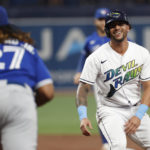 
              Tampa Bay Rays' David Peralta smiles as he is caught in a rundown, between Toronto Blue Jays first baseman Vladimir Guerrero Jr., foreground, and another player during the second inning of a baseball game Saturday, Sept. 24, 2022, in St. Petersburg, Fla. Peralta was tagged out. (AP Photo/Scott Audette)
            