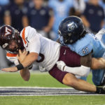 
              Virginia Tech quarterback Grant Wells (6) is tackled by Old Dominion defensive end Kris Caine (41) during an NCAA college football game on Friday, Sept. 2, 2022, in Norfolk, Va. (AP Photo/Mike Caudill)
            