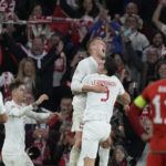 
              Poland's Karol Swiderski celebrates after scoring his side's opening goal during the UEFA Nations League soccer match between Wales and Poland at the Cardiff City Stadium in Cardiff, Wales, Sunday, Sept. 25, 2022. (AP Photo/Frank Augstein)
            