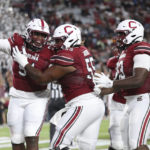 
              South Carolina's Tonka Hemingway (91) celebrates with Jakai Moore (55) after rushing for a 2-point conversion during the first half of the team's NCAA college football game against South Carolina State on Thursday, Sept. 29, 2022, in Columbia, S.C. (AP Photo/Artie Walker Jr.)
            