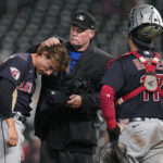 
              Home plate umpire Ted Barrett, middle, checks the hair of Cleveland Guardians relief pitcher James Karinchak for illegal substances during the eighth inning of the team's baseball game against the Minnesota Twins, Friday, Sept. 9, 2022, in Minneapolis. (AP Photo/Abbie Parr)
            