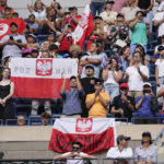 
              Fans wave the Polish and Tunisian flags after Iga Swiatek, of Poland, defeated Ons Jabeur, of Tunisia, the women's singles final of the U.S. Open tennis championships, Saturday, Sept. 10, 2022, in New York. (AP Photo/Charles Krupa)
            