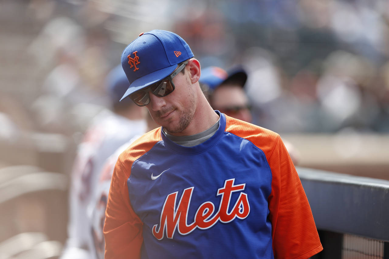 New York Mets starting pitcher Max Scherzer looks on in the dugout during the third inning of a bas...