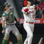 
              Los Angeles Angels' Shohei Ohtani, right, looks up with Oakland Athletics catcher Sean Murphy as Ohtani flies out during the fifth inning of a baseball game in Anaheim, Calif., Wednesday, Sept. 28, 2022. (AP Photo/Alex Gallardo)
            