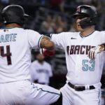 
              Arizona Diamondbacks' Christian Walker (53) celebrates with Ketel Marte (4) after hitting a two-run home run against the Milwaukee Brewers during the first inning of a baseball game Thursday, Sept. 1, 2022, in Phoenix. (AP Photo/Matt York)
            