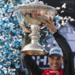 
              Team Penske driver Will Power, of Australia, holds up the championship trophy after winning the championship after the IndyCar season finale auto race at Laguna Seca Raceway on Sunday, Sept. 11, 2022, Monterey, Calif. (AP Photo/Nic Coury)
            