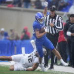 
              Air Force wide receiver Dane Kinamon, front, is knocked out of bounds by Colorado linebacker Quinn Perry in the first half of an NCAA college football game Saturday, Sept. 10, 2022, at Air Force Academy, Colo. (AP Photo/David Zalubowski)
            