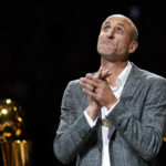 
              FILE - Former San Antonio Spurs guard Manu Ginobili watches as his jersey is unveiled in the rafters of the AT&T Center during his retirement ceremony after the Spurs' NBA basketball game against the Cleveland Cavaliers, Thursday, March 28, 2019, in San Antonio. The four-time NBA champion with the Spurs is one of the headliners for Saturday night’s enshrinement ceremony in Springfield, Massachusetts. (AP Photo/Darren Abate, File)
            