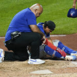 
              Toronto Blue Jays' Santiago Espinal, right, is tended after being hit by a pitch from Pittsburgh Pirates relief pitcher Duane Underwood Jr. during the eighth inning of a baseball game, Saturday, Sept. 3, 2022, in Pittsburgh. Espinal was helped up and walked off the field but did not return to the game. (AP Photo/Keith Srakocic)
            