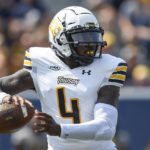 
              Towson quarterback Tyrrell Pigrome (4) makes a pass against West Virginia during the first half of an NCAA college football game in Morgantown, W.Va., Saturday, Sept. 17, 2022. (AP Photo/William Wotring)
            