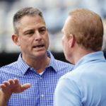 
              FILE - Kansas City Royals General Manager Dayton Moore, left, talks with Royals' TV broadcaster Rex Hudler, right, during batting practice before a baseball game against the Houston Astros in Kansas City, Mo., Saturday, June 4, 2022. The Kansas City Royals, Wednesday, Sept. 21, 2022, fired longtime general manager Dayton Moore.(AP Photo/Colin E. Braley, File)
            
