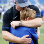 
              Kentucky head coach Mark Stoops hugs and kisses his son, Zack, after winning an NCAA college football game against Youngstown State in Lexington, Ky., Saturday, Sept. 17, 2022. (AP Photo/Michael Clubb)
            