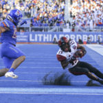 
              San Diego State running back Jordan Byrd (15) loses his footing in front of Boise State linebacker DJ Schramm (52) on a run during the first half of an NCAA college football game Friday, Sept. 30, 2022, in Boise, Idaho. (AP Photo/Steve Conner)
            
