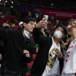 
              China's Han Xu poses for a selfie with fans following during their game at the women's Basketball World Cup against Puerto Rico in Sydney, Australia, Monday, Sept. 26, 2022. (AP Photo/Mark Baker)
            