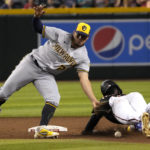 
              Milwaukee Brewers shortstop Willy Adames (27) tries to tag out Arizona Diamondbacks' Geraldo Perdomo, right, in the sixth inning during a baseball game, Saturday, Sept. 3, 2022, in Phoenix. (AP Photo/Rick Scuteri)
            