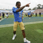 
              UCLA quarterback Dorian Thompson-Robinson (1) points to a fan after an NCAA college football game against Alabama State in Pasadena, Calif., Saturday, Sept. 10, 2022. UCLA won 45-7. (AP Photo/Ashley Landis)
            