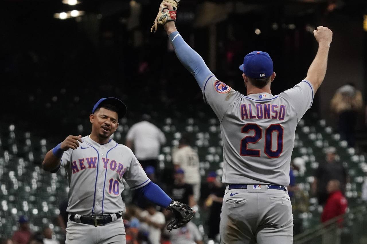 New York Mets' Eduardo Escobar and Pete Alonso celebrate after a baseball game against the Milwauke...