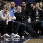
              FILE - Phoenix Suns owner Robert Sarver, center, watches during the second half of an NBA basketball game against the Minnesota Timberwolves, Saturday, Dec. 15, 2018, in Phoenix. The NBA has suspended Phoenix Suns and Phoenix Mercury owner Robert Sarver for one year, plus fined him $10 million, after an investigation found that he had engaged in what the league called “workplace misconduct and organizational deficiencies." The findings of the league's report, published Tuesday, Sept. 13, 2022, came nearly a year after the NBA asked a law firm to investigate allegations that Sarver had a history of racist, misogynistic and hostile incidents over his nearly two-decade tenure overseeing the franchise. (AP Photo/Ralph Freso, File)
            