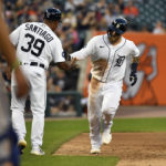 
              Detroit Tigers' Tucker Barnhart, right, is congratulated by Tigers third base coach Ramon Santiago after hitting a home run against the Kansas City Royals in the fifth inning of a baseball game, Saturday, Sept. 3, 2022, in Detroit. (AP Photo/Jose Juarez)
            
