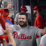 
              Philadelphia Phillies' Kyle Schwarber celebrates in the dugout after hitting a solo home run during the fourth inning of the team's baseball game against the Atlanta Braves on Friday, Sept. 16, 2022, in Atlanta. (AP Photo/John Bazemore)
            