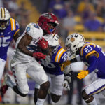 
              New Mexico running back Nathaniel Jones (25) carries against LSU linebacker Micah Baskerville (23) and linebacker Greg Penn III (30) in the second half of an NCAA college football game in Baton Rouge, La., Saturday, Sept. 24, 2022. LSU won 38-0. (AP Photo/Gerald Herbert)
            