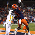 
              Illinois defensive back Jartavius Martin (21) intercepts a pass intended for Chattanooga wide receiver Tyron Arnett in the end zone during the first half of an NCAA college football game Thursday, Sept. 22, 2022, in Champaign, Ill. (AP Photo/Charles Rex Arbogast)
            