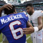 
              Miami Dolphins quarterback Tua Tagovailoa (1) talks to Buffalo Bills wide receiver Isaiah McKenzie (6) after an NFL football game, Sunday, Sept. 25, 2022, in Miami Gardens, Fla. The Dolphins defeated the Bills 21-19. (AP Photo/Rebecca Blackwell)
            