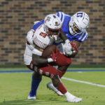 
              Temple's Edward Saydee (23) is tackled in the backfield by Duke's DeWayne Carter, right, during the first half of an NCAA college football game in Durham, N.C., Friday, Sept. 2, 2022. (AP Photo/Ben McKeown)
            