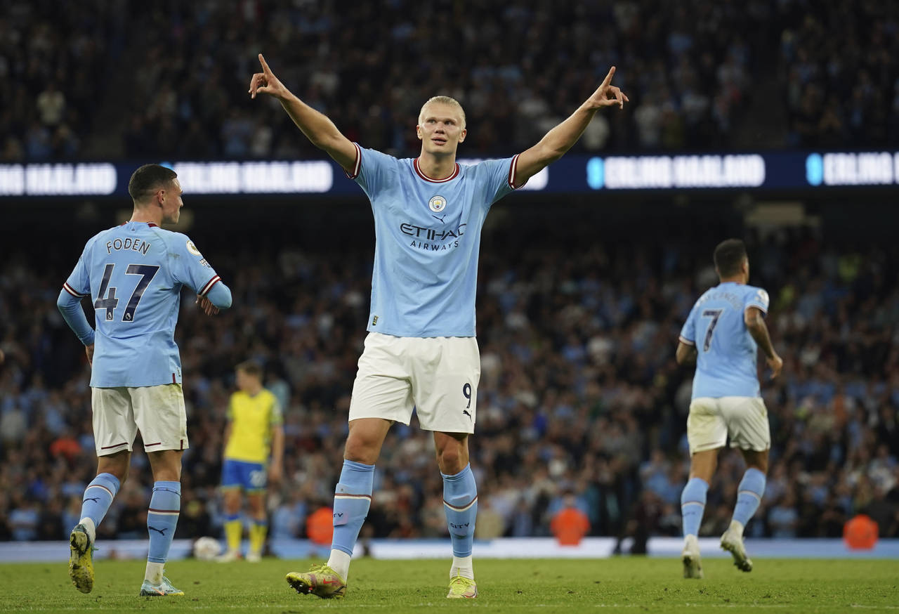 Manchester City's Erling Haaland, centre, celebrates after scoring his side's third goal during the...