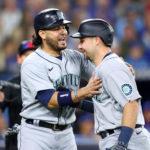 TORONTO, ON - OCTOBER 07:  Cal Raleigh #29 of the Seattle Mariners celebrates with Eugenio Suarez #28 after hitting a 2 run home run in the first inning during Game One of the AL Wild Card series against the Toronto Blue Jays at Rogers Centre on October 7, 2022 in Toronto, Ontario, Canada.  (Photo by Vaughn Ridley/Getty Images)