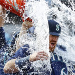 SEATTLE, WASHINGTON - OCTOBER 01: Brian O'Keefe #64 of the Seattle Mariners is doused with water after his first MLB hit in the  Seattle Mariners' 5-1 win against the Oakland Athletics at T-Mobile Park on October 01, 2022 in Seattle, Washington. (Photo by Steph Chambers/Getty Images)