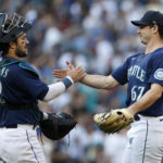 SEATTLE, WASHINGTON - OCTOBER 01: Luis Torrens #22 and Matthew Festa #67 of the Seattle Mariners celebrate their team's 5-1 win against the Oakland Athletics at T-Mobile Park on October 01, 2022 in Seattle, Washington. (Photo by Steph Chambers/Getty Images)