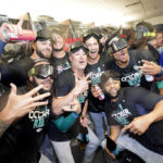 TORONTO, ONTARIO - OCTOBER 08: The Seattle Mariners celebrate in the locker room after defeating the Toronto Blue Jays in game two to win the American League Wild Card Series at Rogers Centre on October 08, 2022 in Toronto, Ontario. The Seattle Mariners defeated the Toronto Blue Jays with a score of 10 to 9. (Photo by Mark Blinch/Getty Images)