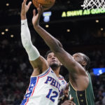 
              Boston Celtics forward Noah Vonleh, right, competes against Philadelphia 76ers forward Tobias Harris (12) for a rebound during the first half of an NBA basketball game Tuesday, Oct. 18, 2022, in Boston. (AP Photo/Charles Krupa)
            