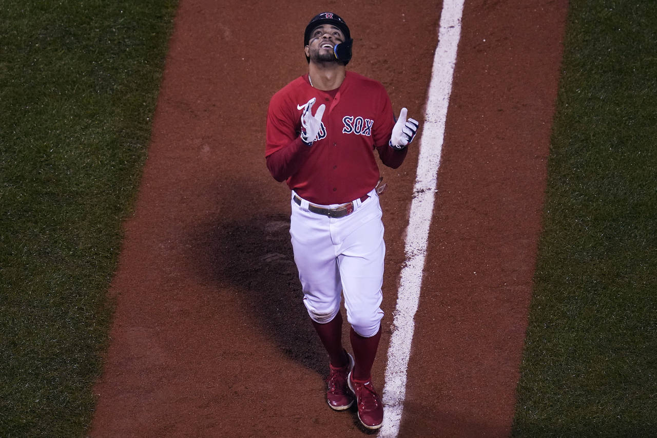 Boston Red Sox's Xander Bogaerts celebrates as heads for home after his grand slam during the fifth...