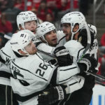 
              Los Angeles Kings center Anze Kopitar, right, celebrates his goal against the Detroit Red Wings in the third period of an NHL hockey game Monday, Oct. 17, 2022, in Detroit. (AP Photo/Paul Sancya)
            