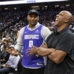 
              Former Sacramento Kings player Metta Standiford-Artest and former San Francisco Giants player Barry Bonds talk while attending an NBA basketball game between the Portland Trail Blazers and the Kings in Sacramento, Calif., Wednesday, Oct. 19, 2022. (AP Photo/José Luis Villegas)
            