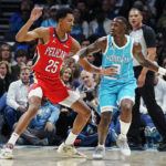 
              New Orleans Pelicans guard Trey Murphy III (25) guards Charlotte Hornets guard Terry Rozier (3) during the first half of an NBA basketball game Friday, Oct. 21, 2022, in Charlotte, N.C. (AP Photo/Rusty Jones)
            