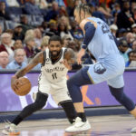 
              Brooklyn Nets guard Kyrie Irving (11) handles the ball against Memphis Grizzlies forward Dillon Brooks (24) in the first half of an NBA basketball game Monday, Oct. 24, 2022, in Memphis, Tenn. (AP Photo/Brandon Dill)
            
