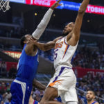 
              Phoenix Suns forward Mikal Bridges, right, goes for a dunk against Los Angeles Clippers guard John Wall during the first half of an NBA basketball game, Sunday, Oct. 23, 2022, in Los Angeles. (AP Photo/Alex Gallardo)
            