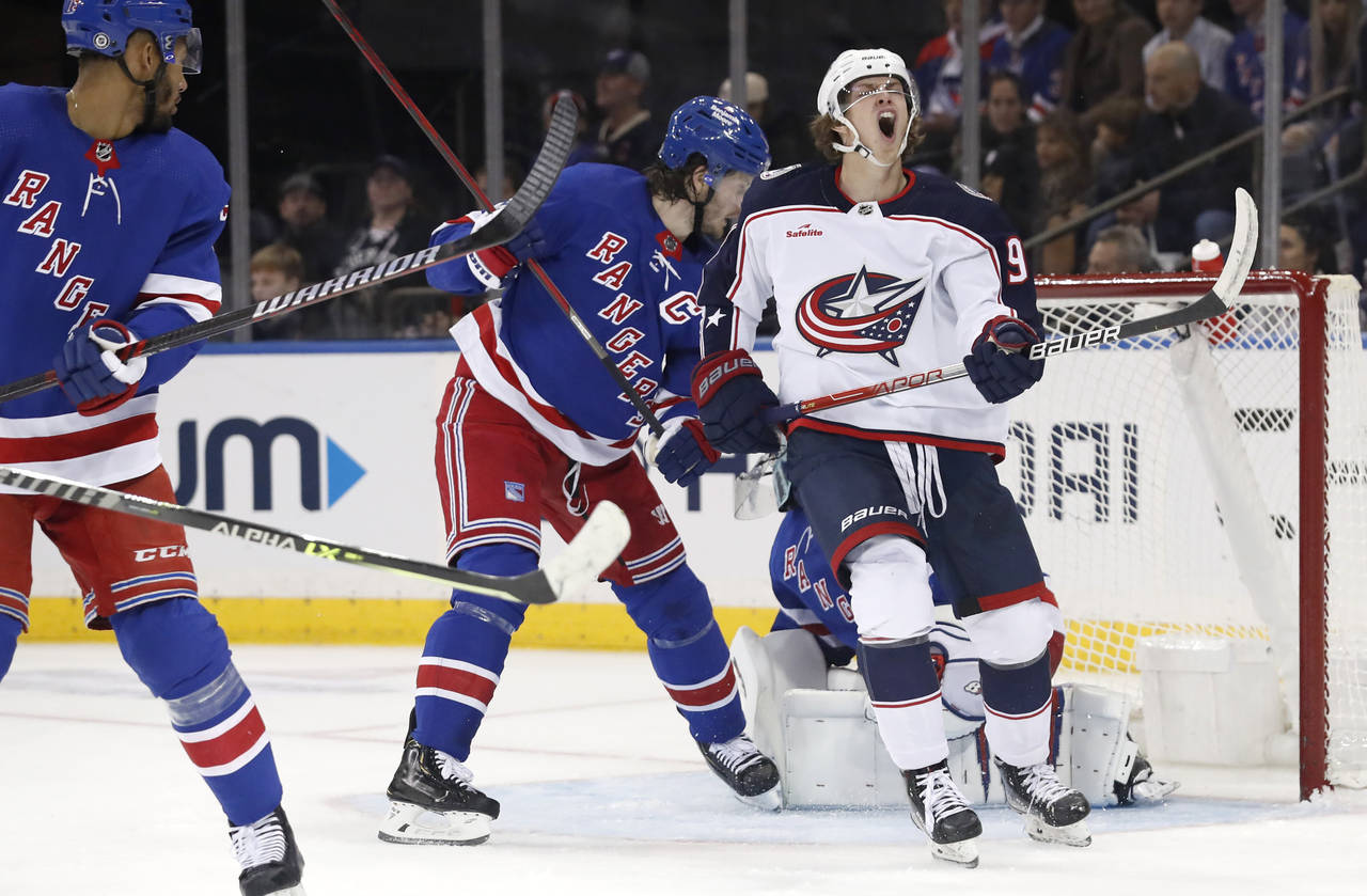 Columbus Blue Jackets center Kent Johnson (91) reacts after missing a shot on goal against the New ...