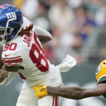 
              New York Giants wide receiver Richie James (80) is tackled by Green Bay Packers cornerback Rasul Douglas (29) during an NFL game between the New York Giants and the Green Bay Packers at the Tottenham Hotspur stadium in London, Sunday, Oct. 9, 2022. (AP Photo/Kin Cheung)
            