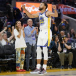 
              Golden State Warriors guard Stephen Curry celebrates after scoring against the Denver Nuggets during the second half of an NBA preseason basketball game in San Francisco, Friday, Oct. 14, 2022. (AP Photo/Jeff Chiu)
            
