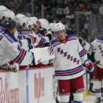 
              New York Rangers defenseman Adam Fox (23) celebrates after scoring a goal during the first period of the team's NHL hockey game against the Minnesota Wild, Thursday, Oct. 13, 2022, in St. Paul, Minn. (AP Photo/Abbie Parr)
            