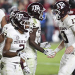 
              Texas A&M quarterback Haynes King (13) congratulates running back Devon Achane (6), who scored a touchdown during the second half of the team's NCAA college football game against South Carolina on Saturday, Oct. 22, 2022, in Columbia, S.C. (AP Photo/Artie Walker Jr.)
            