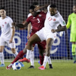 
              FILE - Panama's Harold Cummings, left, and Canada's Cyle Larin battle for the ball during a qualifying soccer match for the FIFA World Cup Qatar 2022 in Panama City, Panama, Wednesday, March 30, 2022. (AP Photo/Arnulfo Franco, File)
            