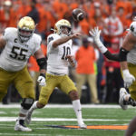 
              Notre Dame quarterback Drew Pyne (10) throws a pass against Syracuse during the second half of an NCAA college football game in Syracuse, N.Y., Saturday, Oct. 29, 2022. (AP Photo/Adrian Kraus)
            