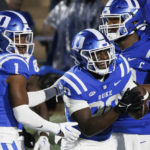 
              Duke's Jaquez Moore (20) celebrates with Jontavis Robertson (1) and Jacob Monk (63) after scoring a touchdown against Virginia during the second half of an NCAA college football game in Durham, N.C., Saturday, Oct. 1, 2022. (AP Photo/Ben McKeown)
            